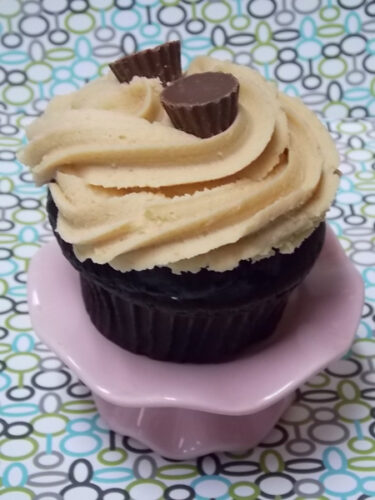 Chocolate cupcake with peanut butter cream icing and mini Reese peanut butter cups
